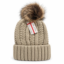 Knit beanie hat in a light beige color featuring a fluffy brown pom pom on top and a ribbed cuff at the base, showcasing a textured cable knit design.