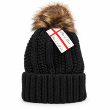 Cozy black beanie hat featuring a textured knit design, a wide ribbed cuff, and a fluffy pom pom at the top; includes a tag attached with a brand name.