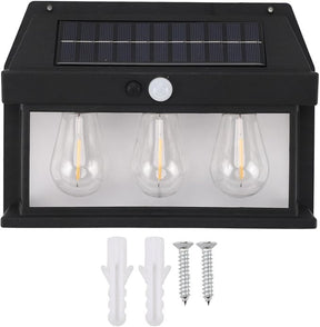 The solar outdoor light features a black housing with three clear, teardrop-shaped bulbs, a motion sensor, and a solar panel on top, accompanied by two wall anchors and two screws for installation. The bulbs are positioned behind a transparent cover, enhancing its sleek design.