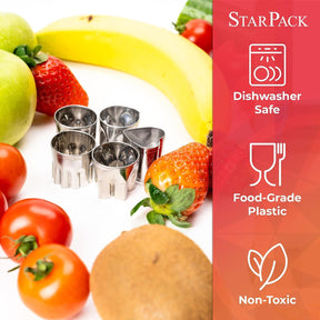 Stainless steel sandwich cutters in various shapes are arranged among colorful fruits and vegetables, including apples, strawberries, tomatoes, and a banana, set against a white background.
