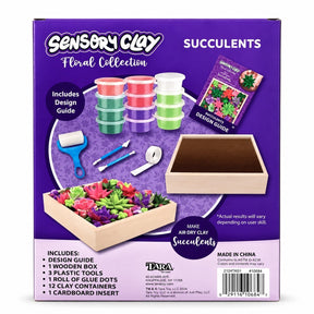 Colorful, air-dry clay containers in pink, green, and purple are displayed alongside crafting tools, a wooden box, and a design guide for creating succulents. The background features a floral pattern and highlights the contents included in the Sensory Clay Floral Collection.