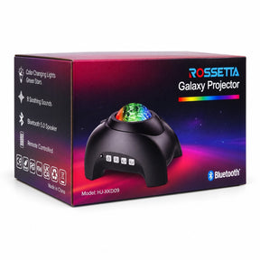 The product packaging features a black box with a colorful design, prominently displaying the Rossetta Galaxy Projector on the top. The projector's dome showcases a vibrant pattern of colors, while the front of the box includes buttons for operation and icons depicting features such as Bluetooth connectivity and soothing sounds.